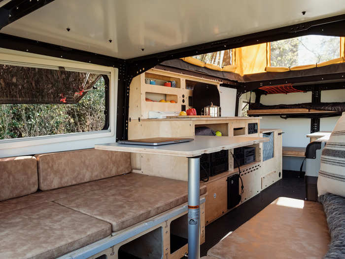 The dining table and lounging area in front of the rear door can seat up to four people.