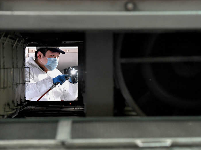 Railways are taking extra precautions. Here, a maintenance worker cleans compartments on the train.