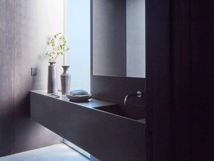 A natural-toned, minimalist look continues throughout the house, even in the bathrooms.