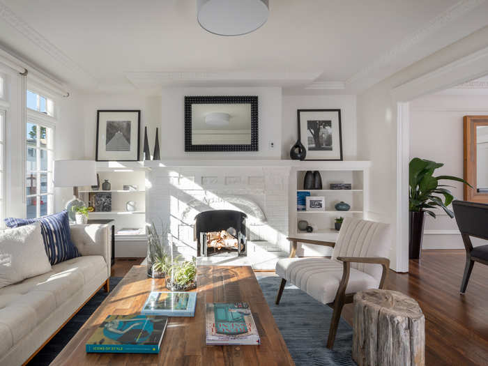 The living room also has built-in shelves and a wood-burning fireplace.