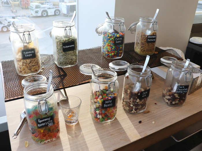 A snack bar with pre-flight favorites including gummy bears and trail mix,...