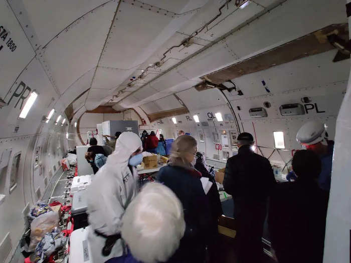  On the flight, passengers could take from boxes of supplies like face masks and water bottles as they boarded the plane. 