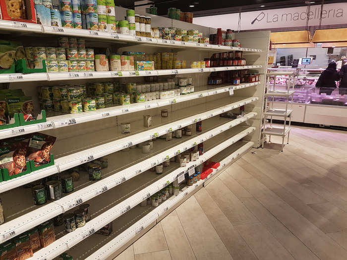 Photos taken by locals in supermarkets in Milan show the empty shelves as customers stocked up on staple items such as pasta, bread, and tinned foods.