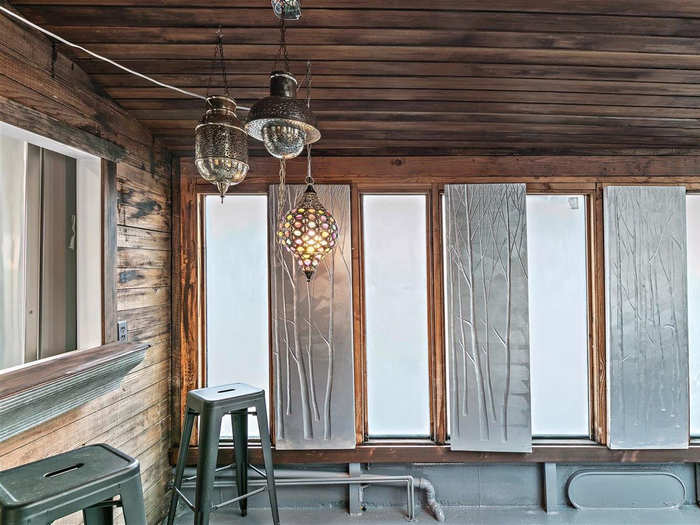 Repurposed, trendy light fixtures help link the old and new spaces.