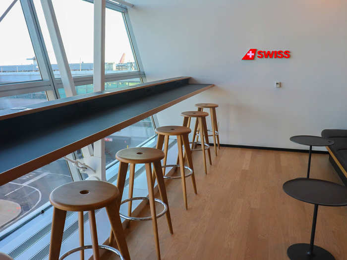 Thanks to its location directly next to the window, the bar-style seats offer some of the best views of the adjacent tarmac in the lounge.