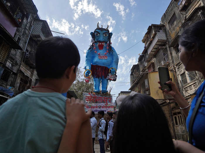 In a residential area near Mumbai, India, devotees depicted the coronavirus as a big, blue demon named "Coronasur."