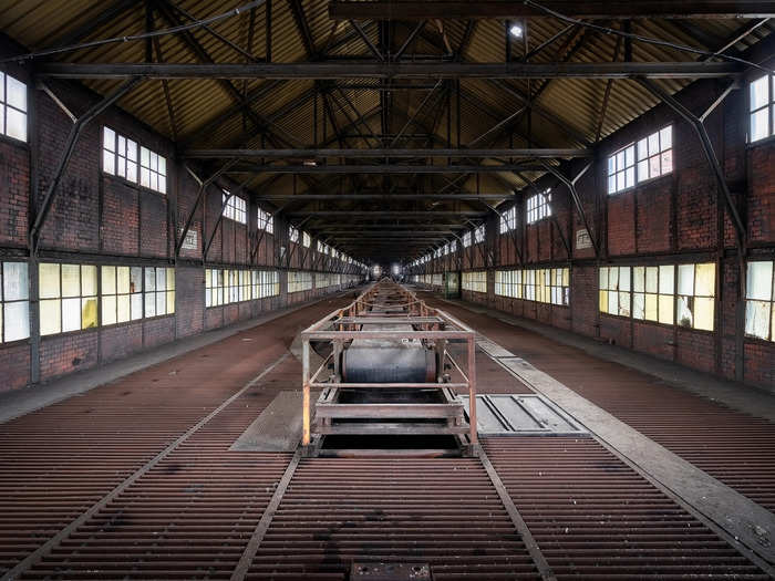 A large conveyor belt is featured in another room that