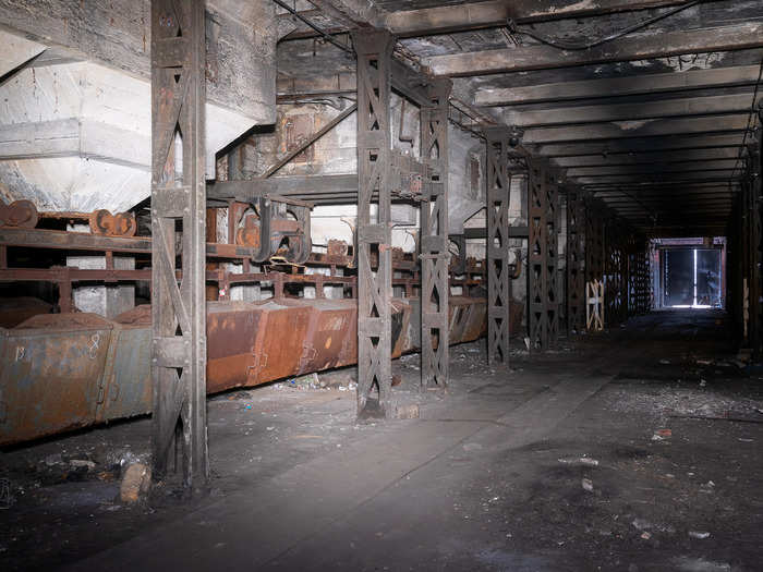 The tunnel, including carriages left behind that were used to transfer coal, was covered in complete darkness.