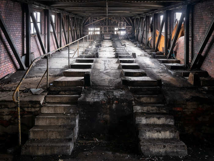 Big concrete stairs leading up to yet another enormous room.