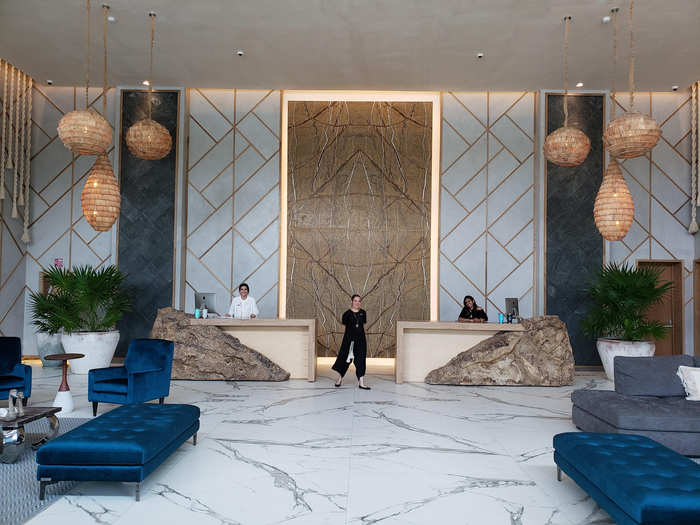 The lobby is gorgeous, with high ceilings, marble floor, and elements that evoke a sense of nature, like thatch lanterns and stone check-in desks. Here, you