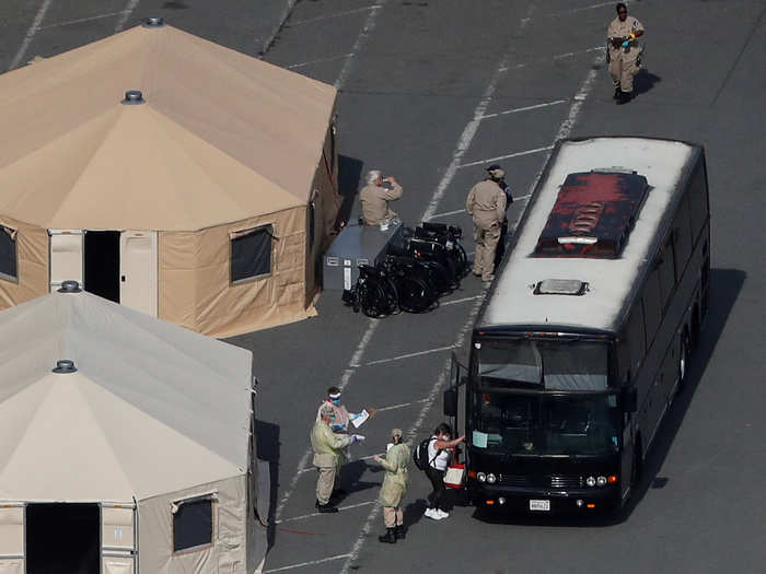 Other passengers boarded buses that would take them to charter planes or nearby military bases, where they will get tested and wait out a 14-day quarantine.