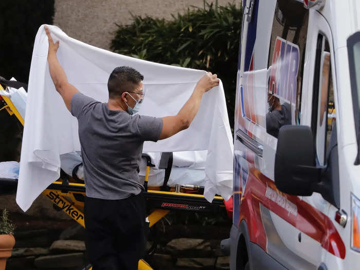 On February 19 the first patient from the care center was transferred to a nearby hospital, and was later confirmed to have the coronavirus. Here, a man is shielding a patient from cameras with a white sheet.