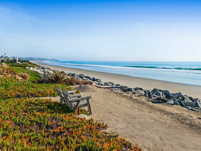 The expansive landscaped yard leads down to 40 feet of beach frontage.