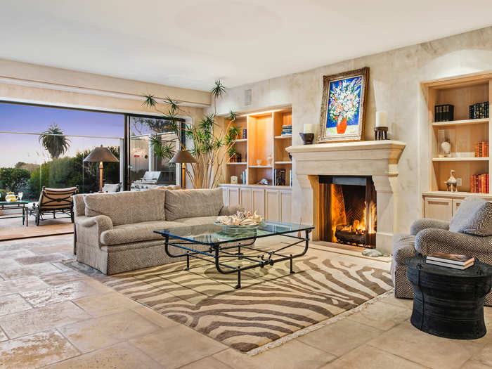 It features tile floors, fireplaces, and living areas that open to outdoor terraces.