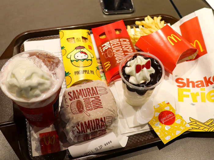 We ordered an impressive spread: a Pork Samurai Burger, McWings, Onigiri Shake Fries, a Lychee Sakura Float, a Hello Kitty chocolate sundae, a cheesy spinach pie, and a pineapple pie.