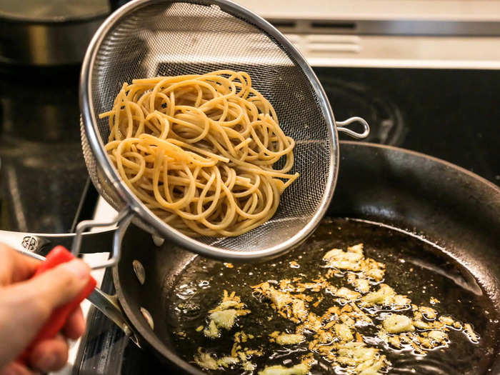 Step 9: Add your drained pasta to the pan.