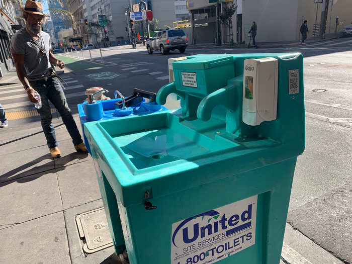 The stations include soap dispensers and two basins with foot pumps that turn the water on.