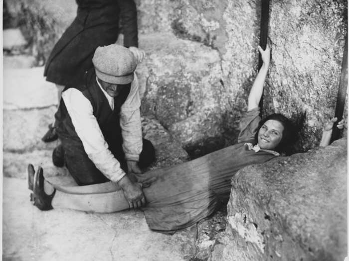 In time, adjustments were made so that visitors could simply lean backward while holding onto iron rails.