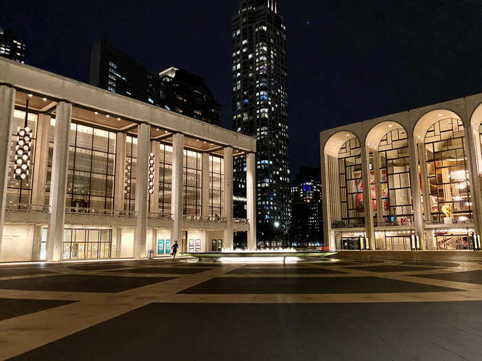 A woman jogs around the fountain at Lincoln Center during the coronavirus disease (COVID-19) outbreak in New York City, March 18, 2020.