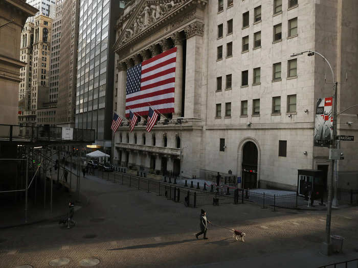 A pedestrian walks on Wall St., as concerns about coronavirus disease (COVID-19) keep more people at home, in front of the New York Stock Exchange (NYSE) in New York, U.S., March 18, 2020.