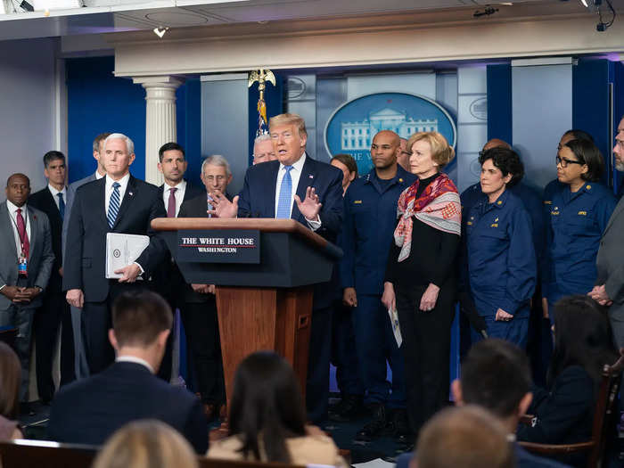 On March 15, two days after Trump declared the virus a national emergency, the CDC recommended limiting gatherings to 50 or less people. At least 14 people stood behind Trump in front of a crowd of reporters in the White House briefing room.