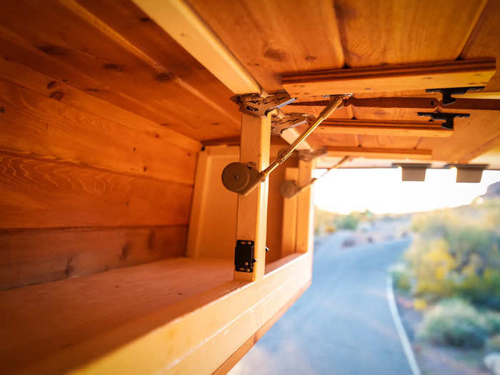 There are also cabinets above the bed for extra storage space.