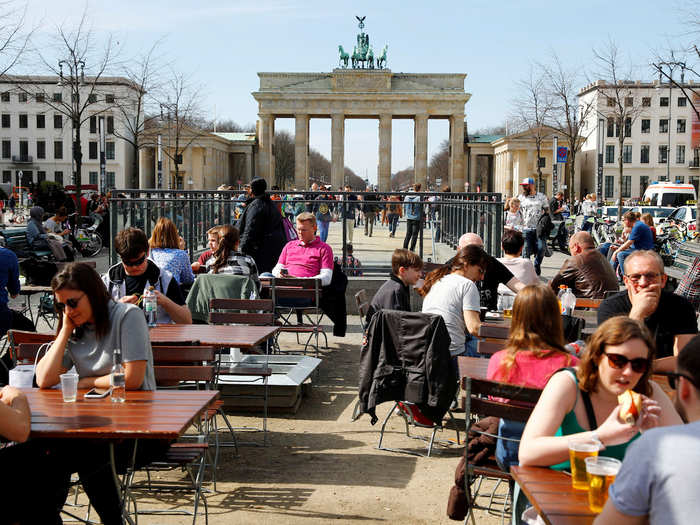 BEFORE: This photo, taken in spring 2018, shows people enjoying drinks and food near the Brandenburg Gate.