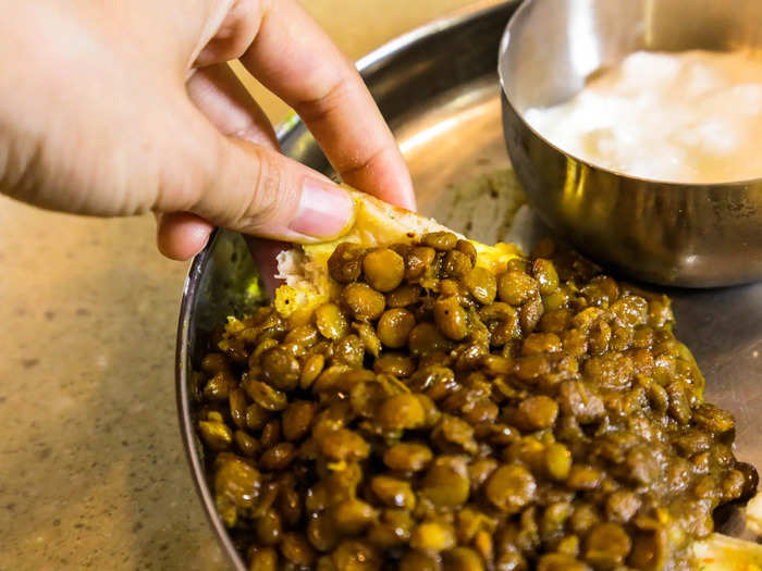 For the Moroccan eating experience, rip off an inch-wide square of bread and push the lentils onto it with your thumb.