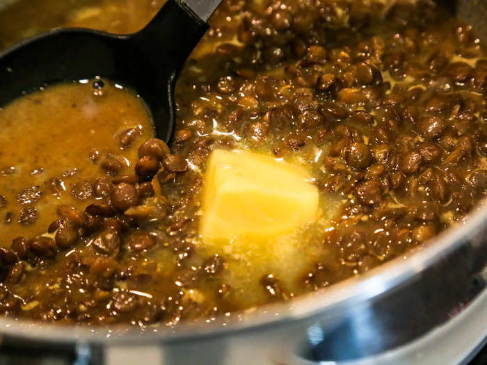 Once the lentils are soft-ish but not done, add a hefty lump of butter — as much as your heart can tolerate. After it