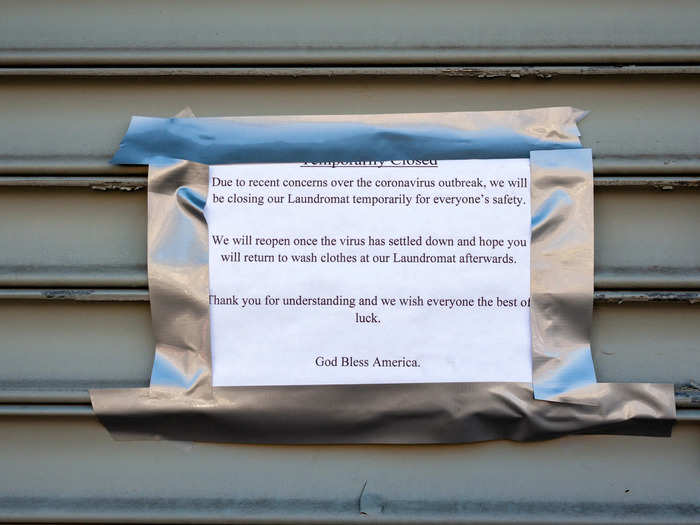 Many essential businesses decided to close too, like this laundromat near the funeral home. "We will reopen once the virus has settled down," its sign reads. But Gov. Andrew Cuomo has said that could take months.