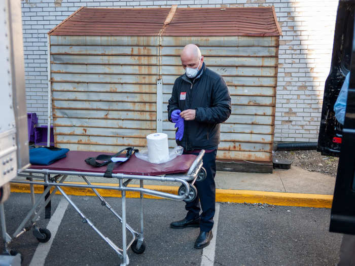 Marmo wheeled out a gurney while his colleague put on two pairs of surgical gloves, a plastic gown, and a face shield. Typically, far fewer precautions are needed.