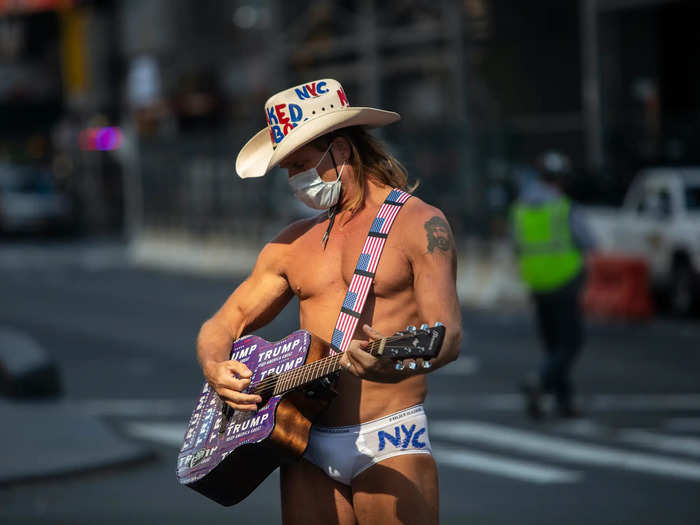 A famous Times Square personality, "The Naked Cowboy" stood amid the empty streets, and wore a mask as he waited for tourists on March 18. But stay-at-home orders and travel restrictions have kept foot traffic low.