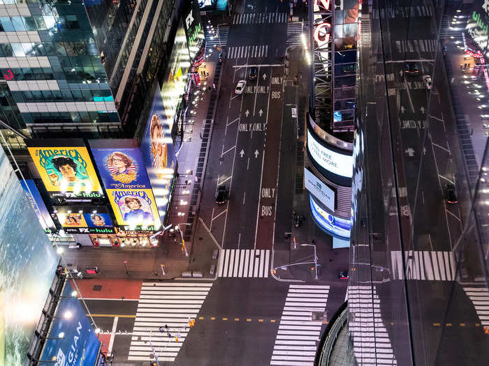 Where the streets are typically littered with tourists, entertainment, and taxis, this aerial shot shows Times Square without a pedestrian in sight.