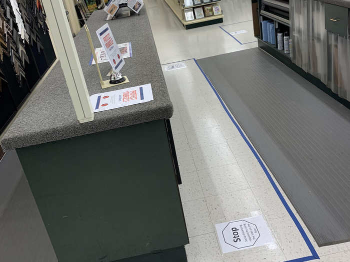 Social distancing barriers have been placed on the ground using tape, in an effort to prevent customers from getting too close to employees.