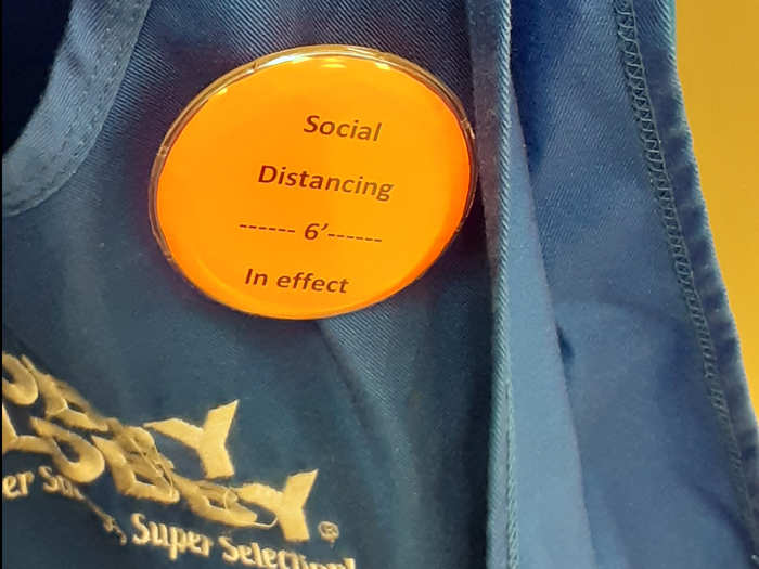 Employees in Ohio and Texas said they had been instructed to wear pins declaring that "social distancing is in effect."