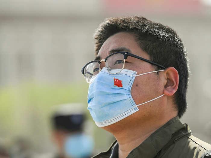 This man in Beijing put a pin of the Chinese flag on his protective face mask to show his support.