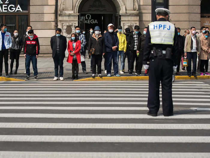 Throngs of pedestrians in Shanghai stopped on the sidewalk to pay their tributes.