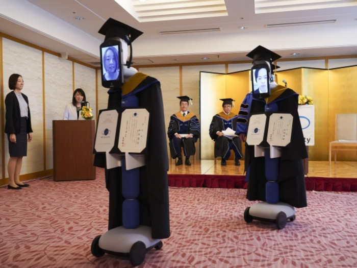 The avatars were controlled by the few graduates who physically attended the ceremony.