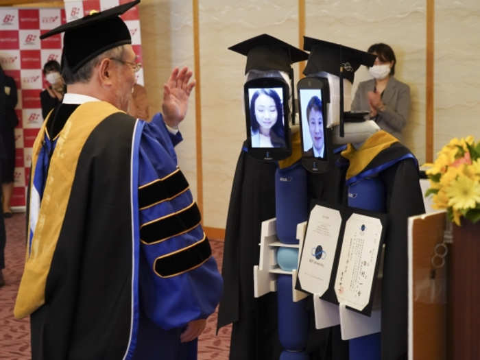 The avatars, which have a tablet in place of a face, were dressed in typical graduation caps and gowns.