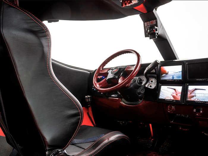 The cockpit also has a racing-style bucket seat and harness ...