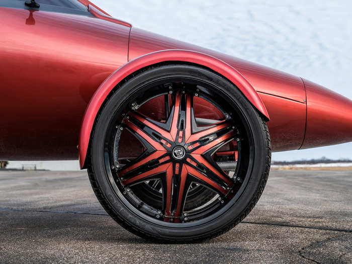 ... and rides on custom, red-and-black, 28-inch wheels.