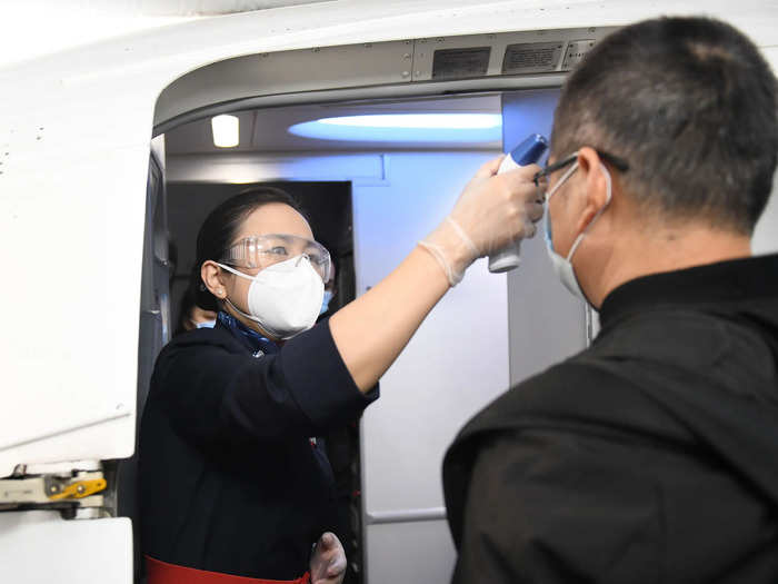 Airline employees were also seen checking people