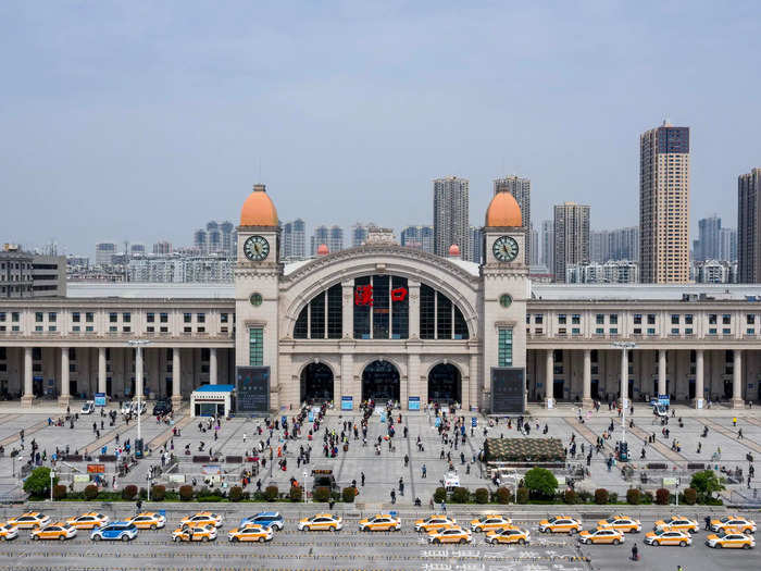 The Hankou Railway Station in Wuhan was bustling with travelers and taxis.