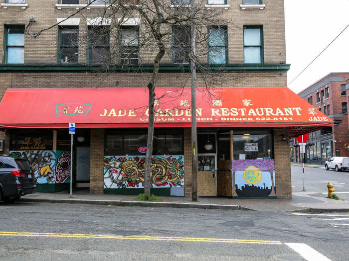 A neon sign flashing "Open" peeked out over a wall of painted-over particleboard.