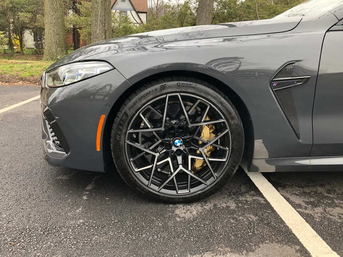 Those are M carbon-ceramic brakes with gold calipers behind the 20-inch bi-color, multi-spoked wheels.