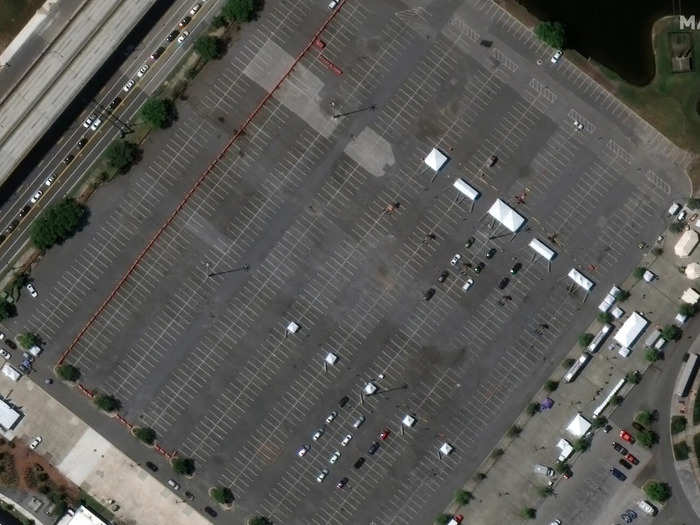 This closer image shows lines of tents set up for cars to drive-thru and get tested. Starting March 23, the parking lot is available for testing symptomatic people of all ages.