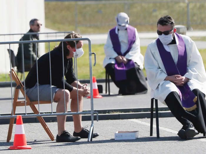 Polish priests moved their confessions outside too on Good Friday, and wore masks while listening to their parishioners.