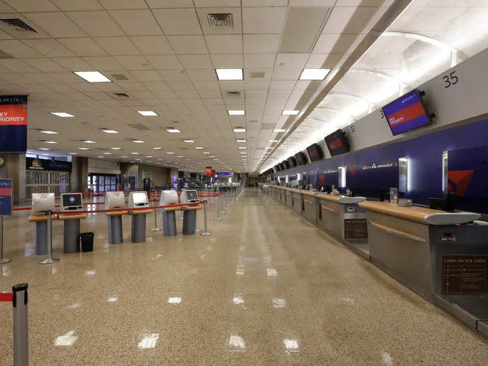 Ticket counters remain similarly empty and largely unstaffed as airlines offer voluntary layoffs for employees in an effort to preserve cash flow.