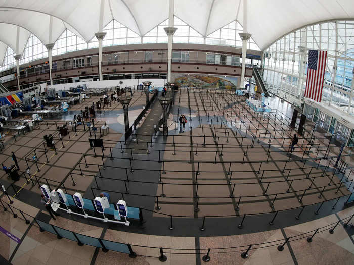 In Denver, the infrastructure remains in place for an empty security checkpoint despite non-existent lines in the normally jam-packed central terminal building.