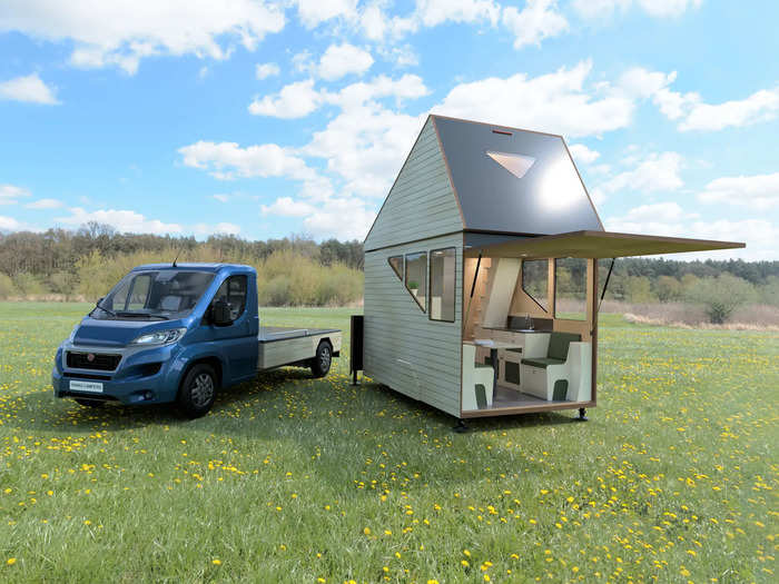 The camper also has a bathroom with a toilet and shower, a seating area, and interior and exterior storage spaces.